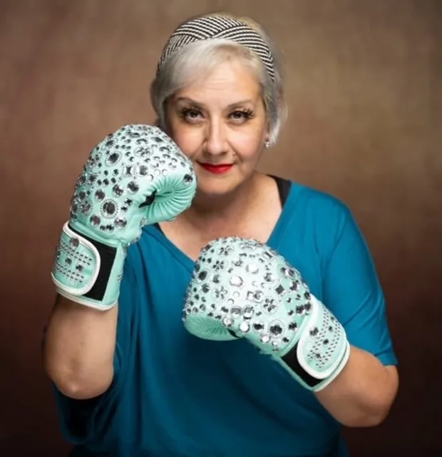 Tina wearing the teal boxing gloves she had covered in crystals.