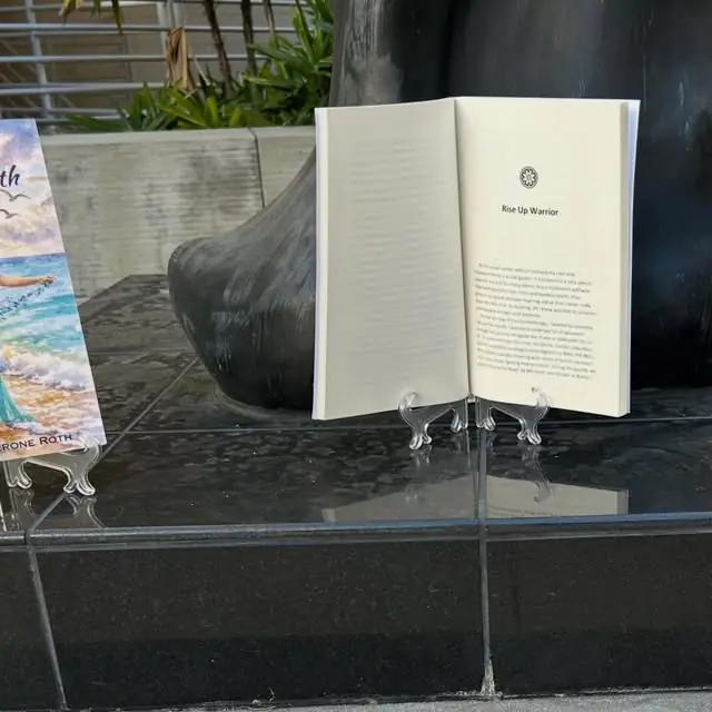 The book open to “Rise Up Warrior” at the base of the Warrior statue in the rock garden.